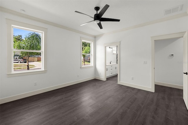 5709 N 20th St, Tampa, FL 33610 - unfurnished bedroom featuring dark wood finished floors, crown molding, ensuite bathroom, and ceiling fan