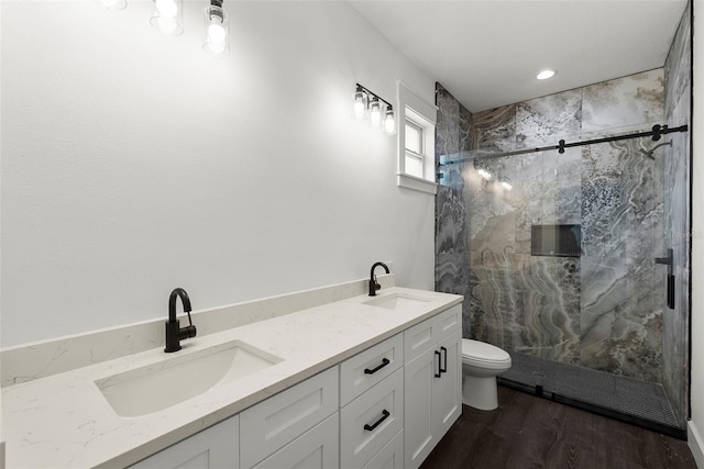 5709 N 20th St, Tampa, FL 33610 - bathroom featuring a marble finish shower, wood finished floors, and double vanity