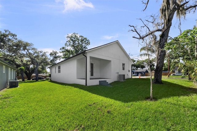 5709 N 20th St, Tampa, FL 33610 - view of side of property featuring a yard and stucco siding