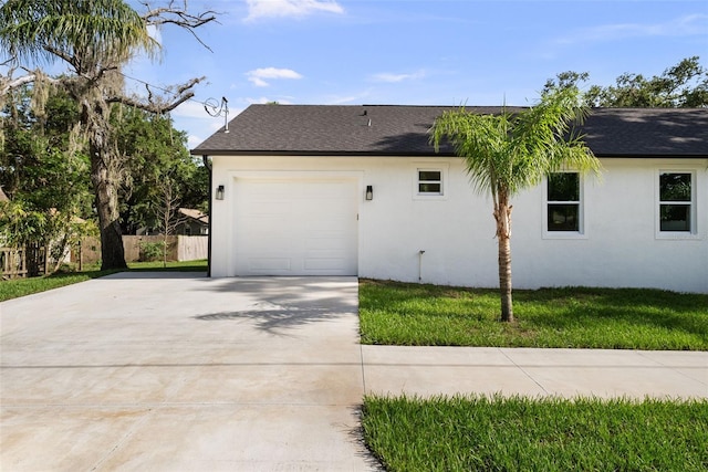 5709 N 20th St, Tampa, FL 33610 - view of side of home with stucco siding, driveway, roof with shingles, and a garage