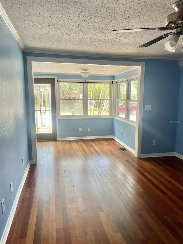 4634 Iris St N, Saint Petersburg, FL 33714 - empty room featuring ceiling fan, crown molding, hardwood / wood-style flooring, baseboards, and a textured ceiling