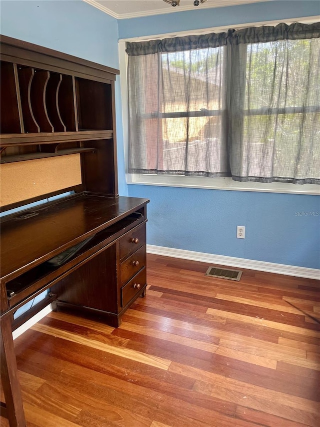 4634 Iris St N, Saint Petersburg, FL 33714 - unfurnished office featuring ornamental molding, wood finished floors, and baseboards