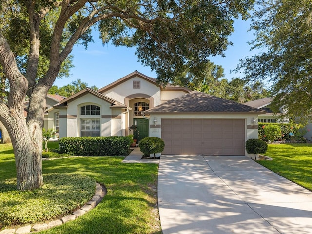 2043 Wrangler Dr, Brandon, FL 33511 - view of front of house featuring an attached garage, stucco siding, a front yard, and driveway