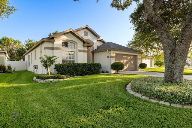 2043 Wrangler Dr, Brandon, FL 33511 - view of front of house featuring stucco siding, a garage, and driveway