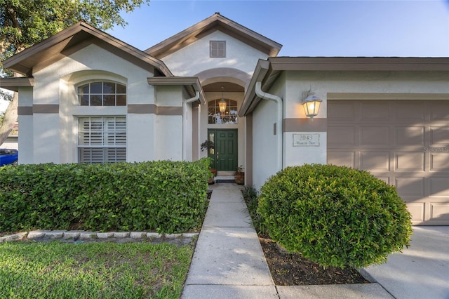 2043 Wrangler Dr, Brandon, FL 33511 - view of front of home with stucco siding and a garage