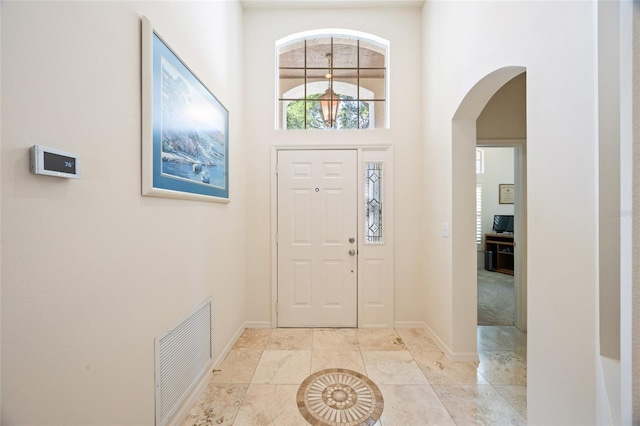 2043 Wrangler Dr, Brandon, FL 33511 - entrance foyer featuring arched walkways, a towering ceiling, and baseboards