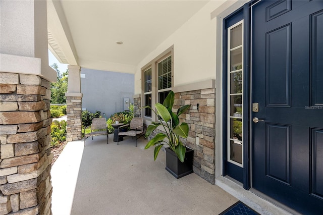 8423 Praise Dr, Tampa, FL 33625 - property entrance with covered porch, stone siding, and stucco siding