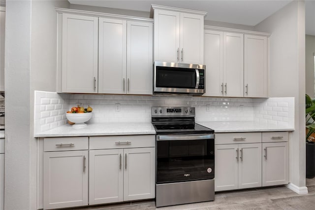 8423 Praise Dr, Tampa, FL 33625 - kitchen with stainless steel appliances, decorative backsplash, and light stone countertops