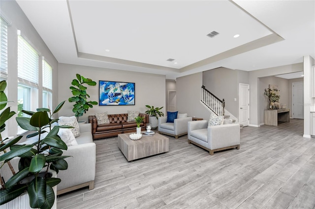 8423 Praise Dr, Tampa, FL 33625 - living area with a tray ceiling, stairway, light wood-style flooring, recessed lighting, and baseboards