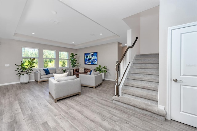 8423 Praise Dr, Tampa, FL 33625 - living room with a raised ceiling, light wood-style floors, stairway, baseboards, and recessed lighting