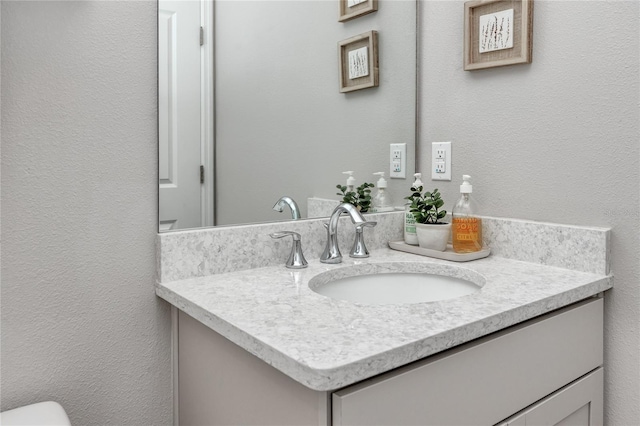 8423 Praise Dr, Tampa, FL 33625 - bathroom featuring vanity, a textured wall, and toilet