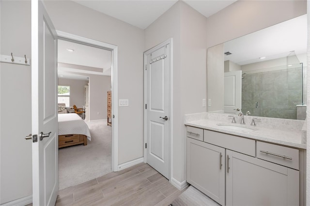 8423 Praise Dr, Tampa, FL 33625 - ensuite bathroom featuring vanity, a shower stall, wood finished floors, and baseboards