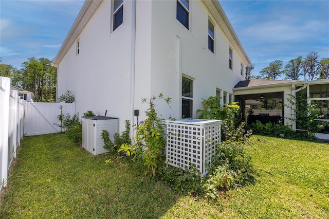 8423 Praise Dr, Tampa, FL 33625 - view of side of property featuring stucco siding, a gate, and central AC