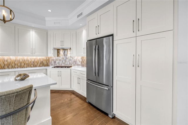 125 Belleview Blvd Unit 203, Belleair, FL 33756 - kitchen featuring freestanding refrigerator, ornamental molding, white cabinets, wood finished floors, and light countertops