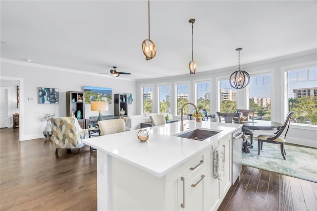125 Belleview Blvd Unit 203, Belleair, FL 33756 - kitchen with crown molding, a chandelier, light countertops, a kitchen island with sink, and white cabinets