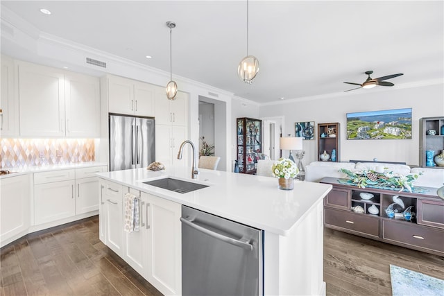 125 Belleview Blvd Unit 203, Belleair, FL 33756 - kitchen featuring stainless steel appliances, dark wood-style flooring, crown molding, light countertops, and decorative light fixtures
