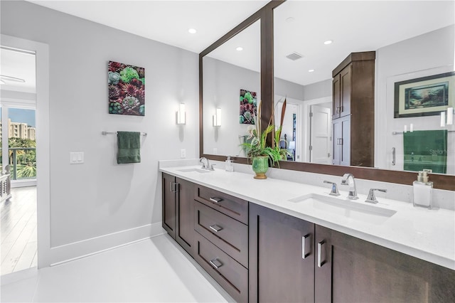 125 Belleview Blvd Unit 203, Belleair, FL 33756 - bathroom with double vanity and baseboards