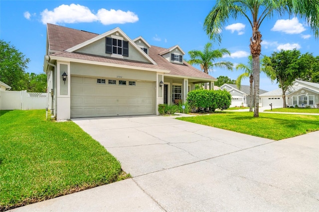 17342 Lawn Orchid Loop, Land O Lakes, FL 34638 - view of front of home featuring stucco siding, concrete driveway, an attached garage, and roof with shingles
