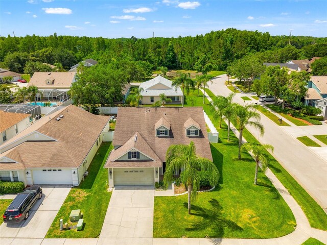 17342 Lawn Orchid Loop, Land O Lakes, FL 34638 - aerial perspective of suburban area with a heavily wooded area