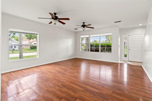 17342 Lawn Orchid Loop, Land O Lakes, FL 34638 - unfurnished room with plenty of natural light, wood finished floors, baseboards, ceiling fan, and recessed lighting