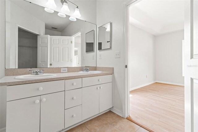 17342 Lawn Orchid Loop, Land O Lakes, FL 34638 - full bathroom featuring double vanity, baseboards, a closet, and tile patterned flooring