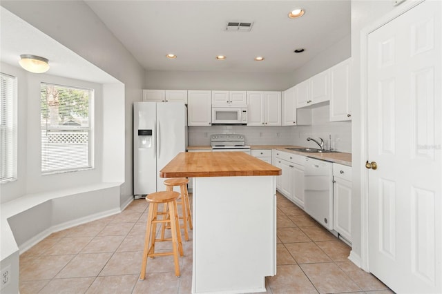 17342 Lawn Orchid Loop, Land O Lakes, FL 34638 - kitchen featuring white appliances, a sink, butcher block countertops, light tile patterned floors, and white cabinets