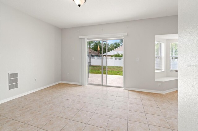 17342 Lawn Orchid Loop, Land O Lakes, FL 34638 - empty room with light tile patterned floors and baseboards