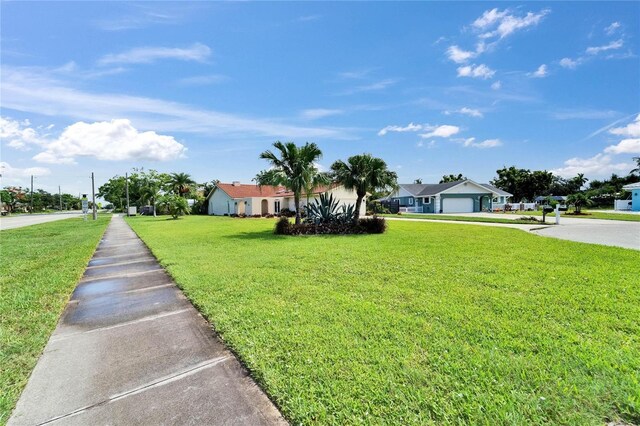 1414 75th St NW, Bradenton, FL 34209 - view of front of home featuring a front lawn, driveway, and a garage
