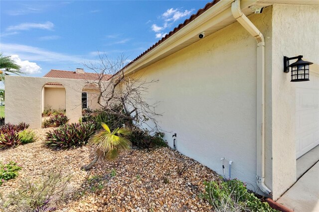 1414 75th St NW, Bradenton, FL 34209 - view of side of home with stucco siding and a tile roof