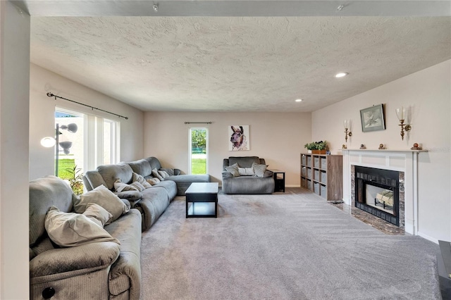 1414 75th St NW, Bradenton, FL 34209 - living area featuring carpet floors, a textured ceiling, a fireplace with flush hearth, and recessed lighting
