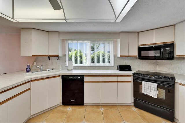 1414 75th St NW, Bradenton, FL 34209 - kitchen featuring black appliances, light countertops, tasteful backsplash, and light tile patterned floors