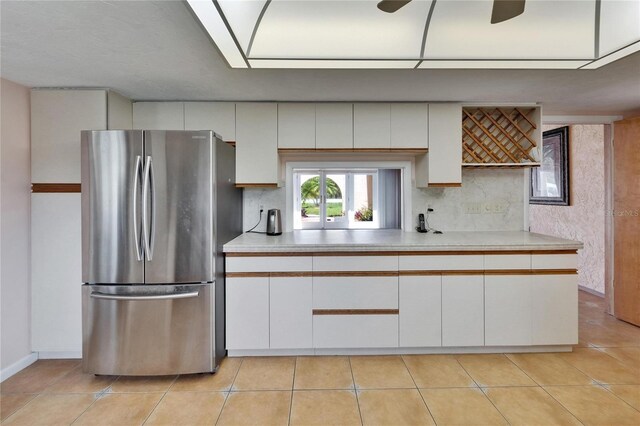 1414 75th St NW, Bradenton, FL 34209 - kitchen with freestanding refrigerator, light countertops, backsplash, and white cabinets