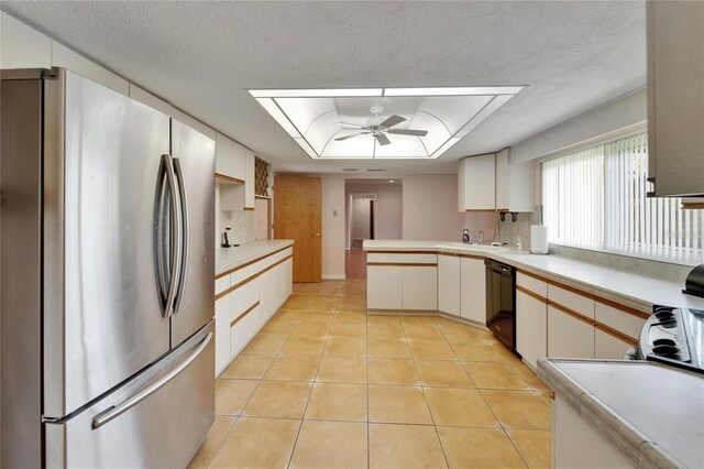 1414 75th St NW, Bradenton, FL 34209 - kitchen featuring freestanding refrigerator, black dishwasher, ceiling fan, light countertops, and light tile patterned floors