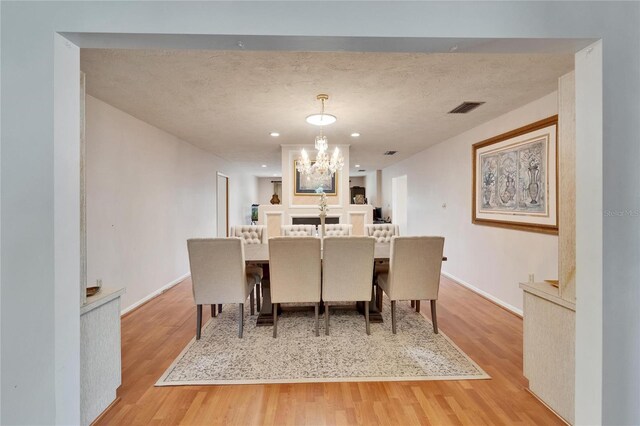 1414 75th St NW, Bradenton, FL 34209 - dining area with a chandelier and light wood-type flooring