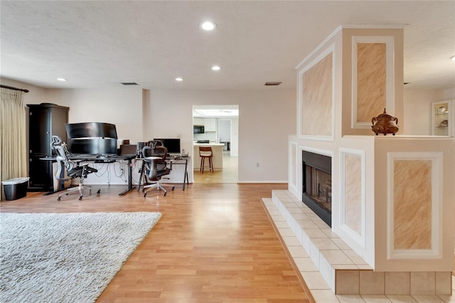 1414 75th St NW, Bradenton, FL 34209 - office space featuring wood finished floors, recessed lighting, and a tile fireplace
