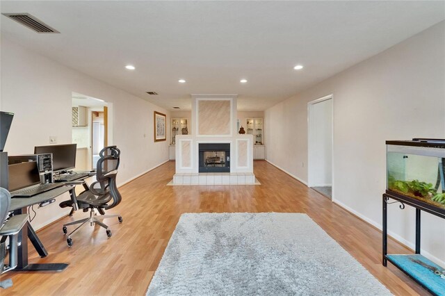 1414 75th St NW, Bradenton, FL 34209 - office with wood finished floors, recessed lighting, and a multi sided fireplace