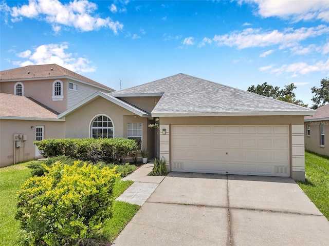 899 Addison Dr NE, Saint Petersburg, FL 33716 - view of front of house with driveway, roof with shingles, a garage, and stucco siding
