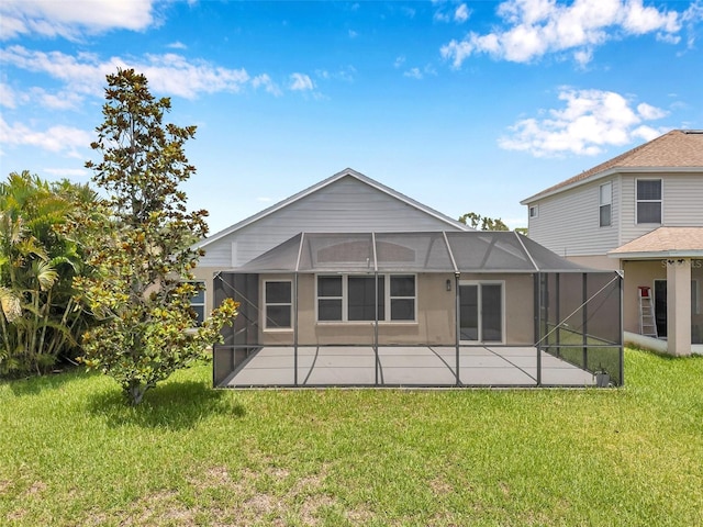 899 Addison Dr NE, Saint Petersburg, FL 33716 - back of property featuring a patio, a lawn, and glass enclosure