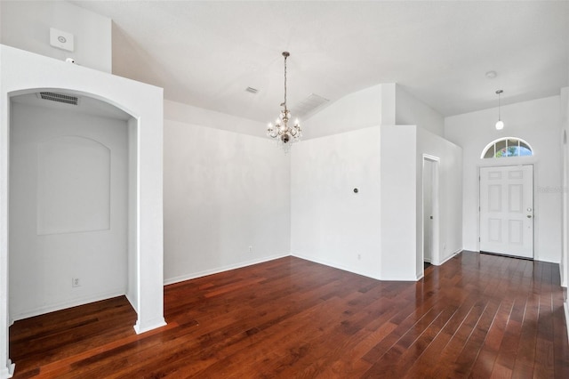 899 Addison Dr NE, Saint Petersburg, FL 33716 - entryway featuring vaulted ceiling, arched walkways, wood finished floors, and a chandelier