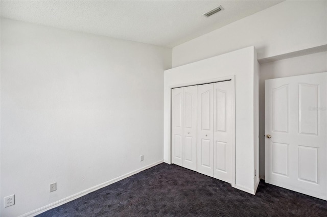 899 Addison Dr NE, Saint Petersburg, FL 33716 - unfurnished bedroom with dark colored carpet and a closet