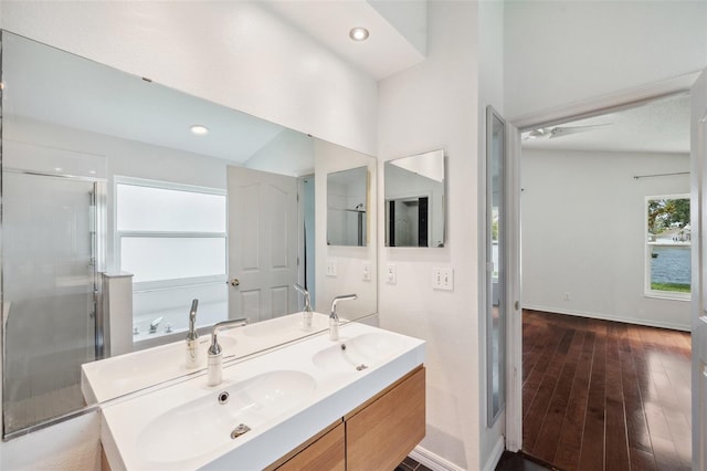 899 Addison Dr NE, Saint Petersburg, FL 33716 - full bath featuring double vanity, a shower stall, hardwood / wood-style flooring, and recessed lighting