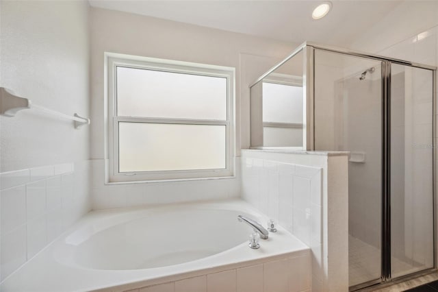 899 Addison Dr NE, Saint Petersburg, FL 33716 - bathroom featuring a stall shower and a garden tub