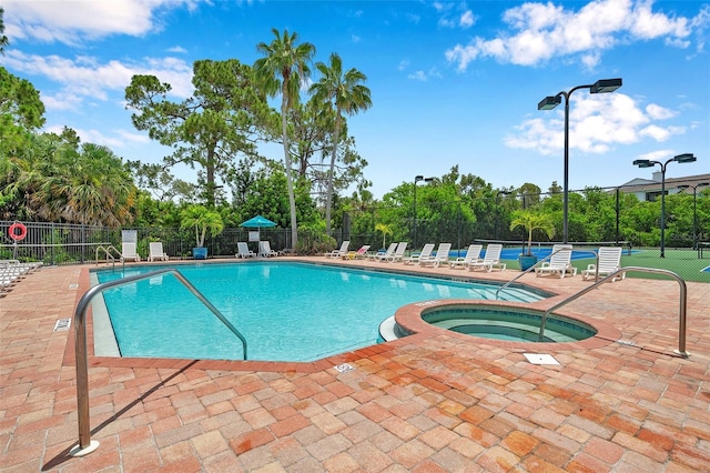899 Addison Dr NE, Saint Petersburg, FL 33716 - community pool featuring a hot tub and a patio