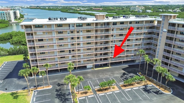 19451 Gulf Blvd Unit 205, Indian Shores, FL 33785 - view of apartment building / complex featuring uncovered parking and a water view