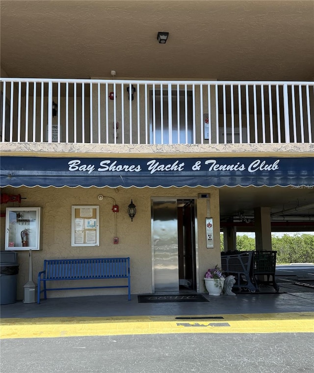 19451 Gulf Blvd Unit 205, Indian Shores, FL 33785 - entrance to property with stucco siding, elevator, and a balcony