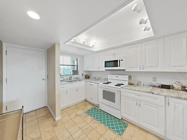 19451 Gulf Blvd Unit 205, Indian Shores, FL 33785 - kitchen with white appliances, white cabinets, and light stone counters
