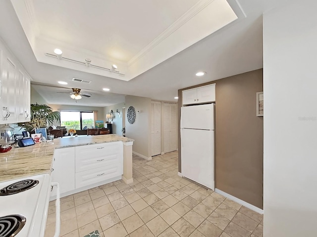19451 Gulf Blvd Unit 205, Indian Shores, FL 33785 - kitchen featuring white appliances, a peninsula, white cabinets, a tray ceiling, and a ceiling fan