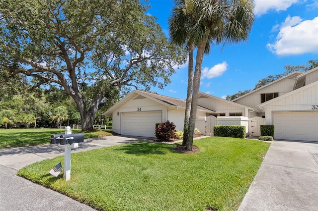 440 Lakeview Dr Unit 34, Palm Harbor, FL 34683 - view of front of home featuring driveway, an attached garage, and a gate
