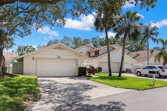 440 Lakeview Dr Unit 34, Palm Harbor, FL 34683 - view of property with concrete driveway, a front lawn, and a garage