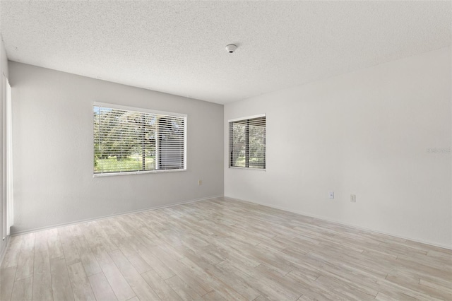 440 Lakeview Dr Unit 34, Palm Harbor, FL 34683 - spare room with light wood-style flooring and a textured ceiling